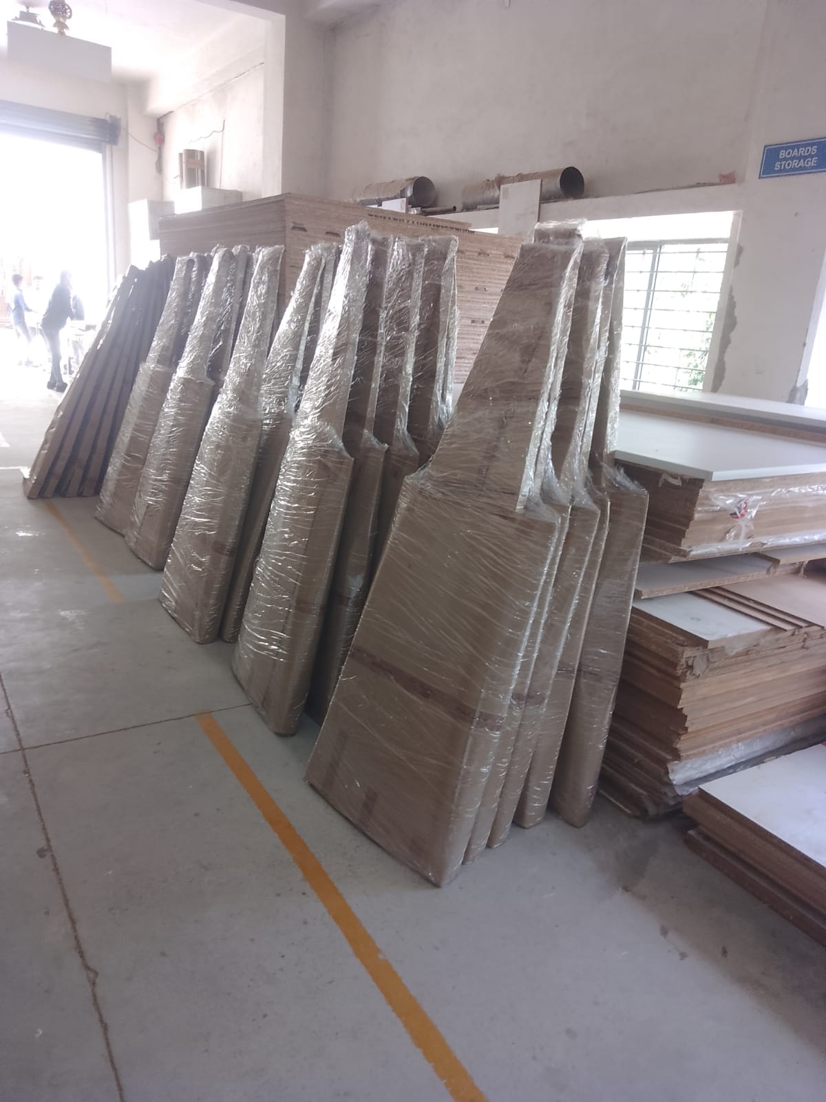 Bulk wooden standees wrapped and prepared for dispatch