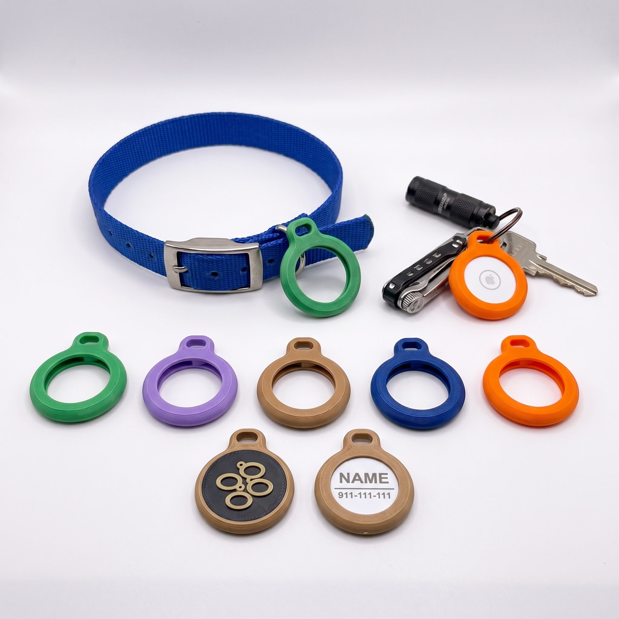 AirTag holder on blue dog collar, plus colored AirTag cases and personalized pet ID plaques with name and phone number