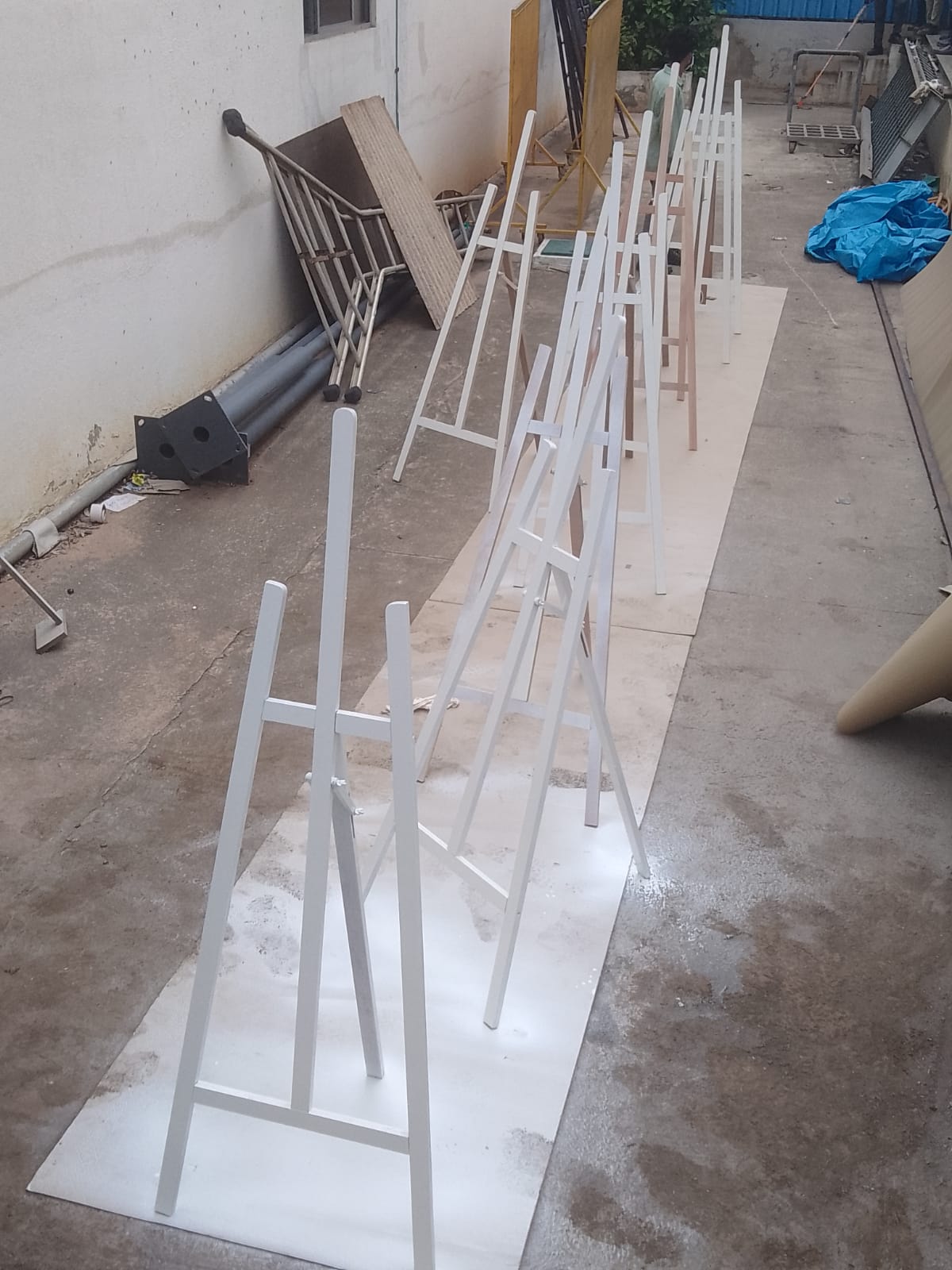 White wooden easels lined up during production